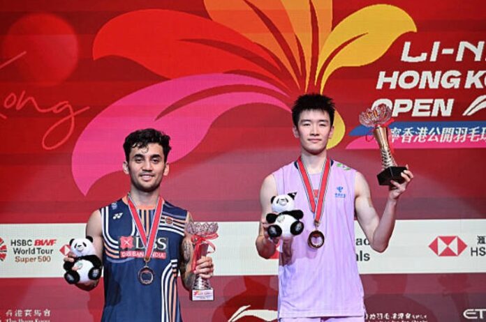 Li Shifeng (R)은 Lakshya Sen. (사진 : AFP)과의 지휘권을 얻은 후 2025 홍콩 오픈 남자 싱글 트로피를 들어 올립니다.